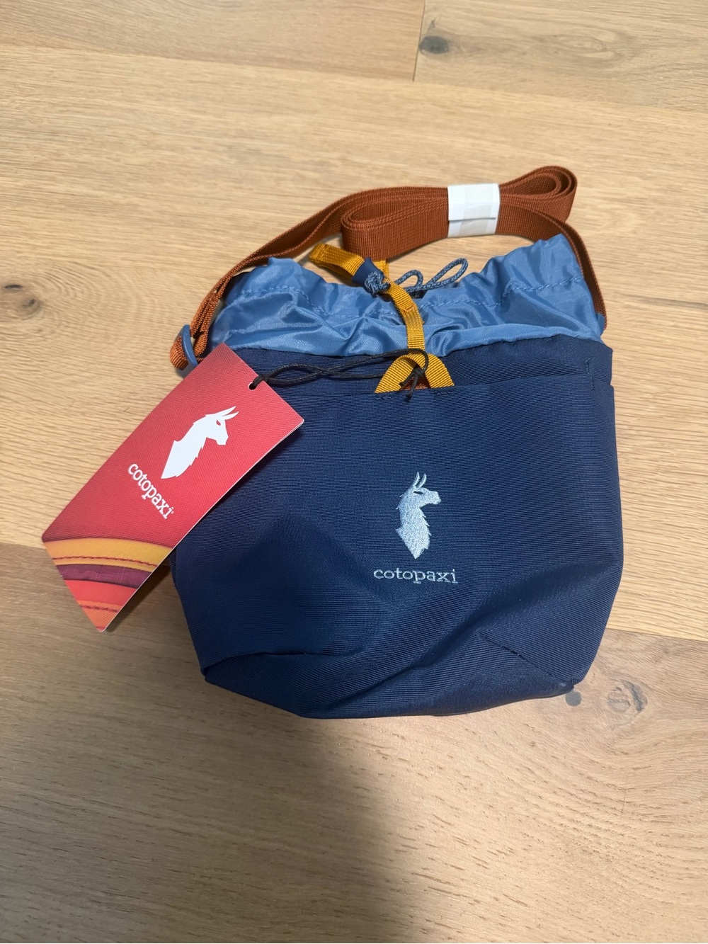 Cotopaxi Navy and Light Blue Drawstring Crossbody Bag with Black Desert logo